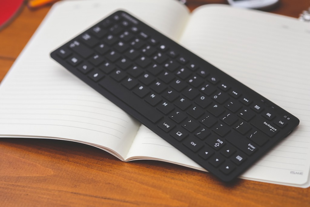 Black desktop wireless keyboard on the note